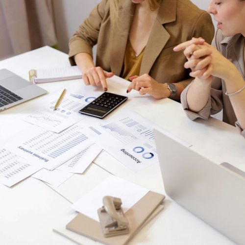 Professionals reviewing financial documents for property management outsource accounting.
